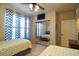 Bright bedroom with two twin beds, mirrored closet, and window coverings at 914 Charo Pkwy # 114, Davenport, FL 33897