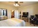 Bright bedroom with king bed, ensuite bathroom access, and home office area at 914 Charo Pkwy # 114, Davenport, FL 33897