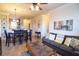 Open concept living and dining area with gray sofas and a dining table at 914 Charo Pkwy # 114, Davenport, FL 33897