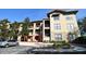 Exterior view of a residential building with parking and landscaping at 914 Charo Pkwy # 114, Davenport, FL 33897