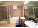 Elegant bathroom with double vanity, soaking tub, and walk-in shower at 914 Charo Pkwy # 114, Davenport, FL 33897