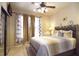 Comfortable bedroom with a queen-size bed and large windows at 914 Charo Pkwy # 114, Davenport, FL 33897