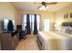 Spacious bedroom with a king-size bed, large TV, and built-in workspace at 914 Charo Pkwy # 114, Davenport, FL 33897