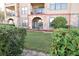 Private patio with arched entryway, stonework, and small seating area at 914 Charo Pkwy # 114, Davenport, FL 33897