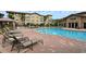 Inviting resort-style pool with plenty of lounge chairs at 914 Charo Pkwy # 114, Davenport, FL 33897
