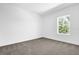 Bright bedroom with large window and carpet flooring at 450 Lake Shore Pkwy, Davenport, FL 33896