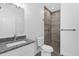 Bathroom with shower, toilet, and granite countertop vanity at 450 Lake Shore Pkwy, Davenport, FL 33896