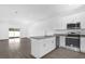 Modern kitchen with island, stainless steel appliances and granite countertops at 450 Lake Shore Pkwy, Davenport, FL 33896