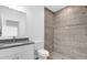Bathroom with shower, toilet, vanity with granite countertop at 450 Lake Shore Pkwy, Davenport, FL 33896