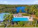 Relaxing community pool with lounge chairs and lush landscaping at 450 Lake Shore Pkwy, Davenport, FL 33896