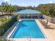 Community pool with a covered patio area and lounge chairs at 450 Lake Shore Pkwy, Davenport, FL 33896