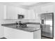 Modern kitchen featuring stainless steel appliances and granite countertops at 450 Lake Shore Pkwy, Davenport, FL 33896