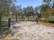 Sand volleyball court nestled among trees at 450 Lake Shore Pkwy, Davenport, FL 33896