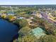 Aerial view of community, tennis court, lake, and residential buildings at 450 Lake Shore Pkwy, Davenport, FL 33896
