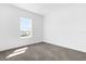 Spacious bedroom with large window and carpet flooring at 450 Lake Shore Pkwy, Davenport, FL 33896