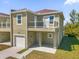 Two-story townhome with attached garage and balcony at 450 Lake Shore Pkwy, Davenport, FL 33896