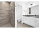 Modern bathroom with double vanity, shower, and tile flooring at 450 Lake Shore Pkwy, Davenport, FL 33896
