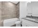 Bathroom with bathtub, toilet and granite countertop vanity at 450 Lake Shore Pkwy, Davenport, FL 33896