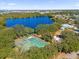 Aerial view of community amenities including tennis courts, lake, and clubhouse at 450 Lake Shore Pkwy, Davenport, FL 33896