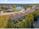 Aerial view of townhouses with brown roofs near a lake at 450 Lake Shore Pkwy, Davenport, FL 33896