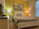 Bedroom with a full-size bed and yellow accent wall at 9033 Rhodes St, Kissimmee, FL 34747