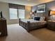 Spacious main bedroom with king-size bed and ensuite bathroom at 9033 Rhodes St, Kissimmee, FL 34747