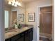 Double vanity bathroom with granite countertop and shower at 9033 Rhodes St, Kissimmee, FL 34747