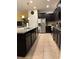 Modern kitchen featuring dark cabinetry, granite countertops, and stainless steel appliances at 9033 Rhodes St, Kissimmee, FL 34747