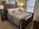 Cozy bedroom with a wooden bed frame and neutral color scheme at 9033 Rhodes St, Kissimmee, FL 34747