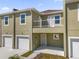 Front view of a two-story townhome with attached garage and balcony at 452 Lake Shore Pkwy, Davenport, FL 33896