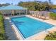 Community pool with lounge chairs and a cabana at 452 Lake Shore Pkwy, Davenport, FL 33896