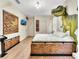 Primary bedroom with dinosaur mural and large bed at 1465 Belle Terre Rd, Davenport, FL 33896