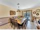 Large dining room table with seating for twelve, adjacent to the living room and pool at 1465 Belle Terre Rd, Davenport, FL 33896