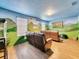 Theater room with brown leather recliners and dinosaur mural at 1465 Belle Terre Rd, Davenport, FL 33896