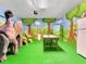 Playroom with air hockey table and dinosaur decor at 1465 Belle Terre Rd, Davenport, FL 33896
