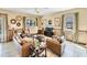 Comfortable living room with leather sofas and large windows at 1465 Belle Terre Rd, Davenport, FL 33896