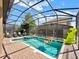 Screened pool and spa with lounge chairs and inflatable toys at 1465 Belle Terre Rd, Davenport, FL 33896