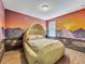 Bedroom with unique dinosaur egg bed and sunset mural at 1465 Belle Terre Rd, Davenport, FL 33896