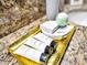 Gold tray with lotions, soap, and bath bombs on a bathroom counter at 1465 Belle Terre Rd, Davenport, FL 33896