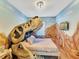 Themed bedroom with dinosaur bed and scenic wall art at 1465 Belle Terre Rd, Davenport, FL 33896