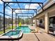 Screened pool and spa with lounge chairs and inflatable toys at 1465 Belle Terre Rd, Davenport, FL 33896