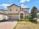 Two-story house with stone accents and landscaping at 1465 Belle Terre Rd, Davenport, FL 33896