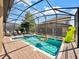 Screened pool and spa with lounge chairs and inflatable toys at 1465 Belle Terre Rd, Davenport, FL 33896