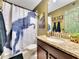 Bathroom with granite countertop and T-Rex shower curtain at 1465 Belle Terre Rd, Davenport, FL 33896