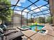 Screened pool and spa with lounge chairs and inflatable toys at 1465 Belle Terre Rd, Davenport, FL 33896