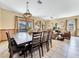 Bright dining room with a large wooden table and seating for eight at 1465 Belle Terre Rd, Davenport, FL 33896