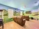 Theater room with brown leather recliners and dinosaur mural at 1465 Belle Terre Rd, Davenport, FL 33896
