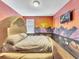 Dinosaur themed bedroom with large mural and unique bed at 1465 Belle Terre Rd, Davenport, FL 33896