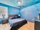 King bedroom with ocean-themed mural and dark blue bedding at 1465 Belle Terre Rd, Davenport, FL 33896