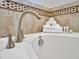 Clean white bathtub with rolled towels and bath accessories at 1465 Belle Terre Rd, Davenport, FL 33896